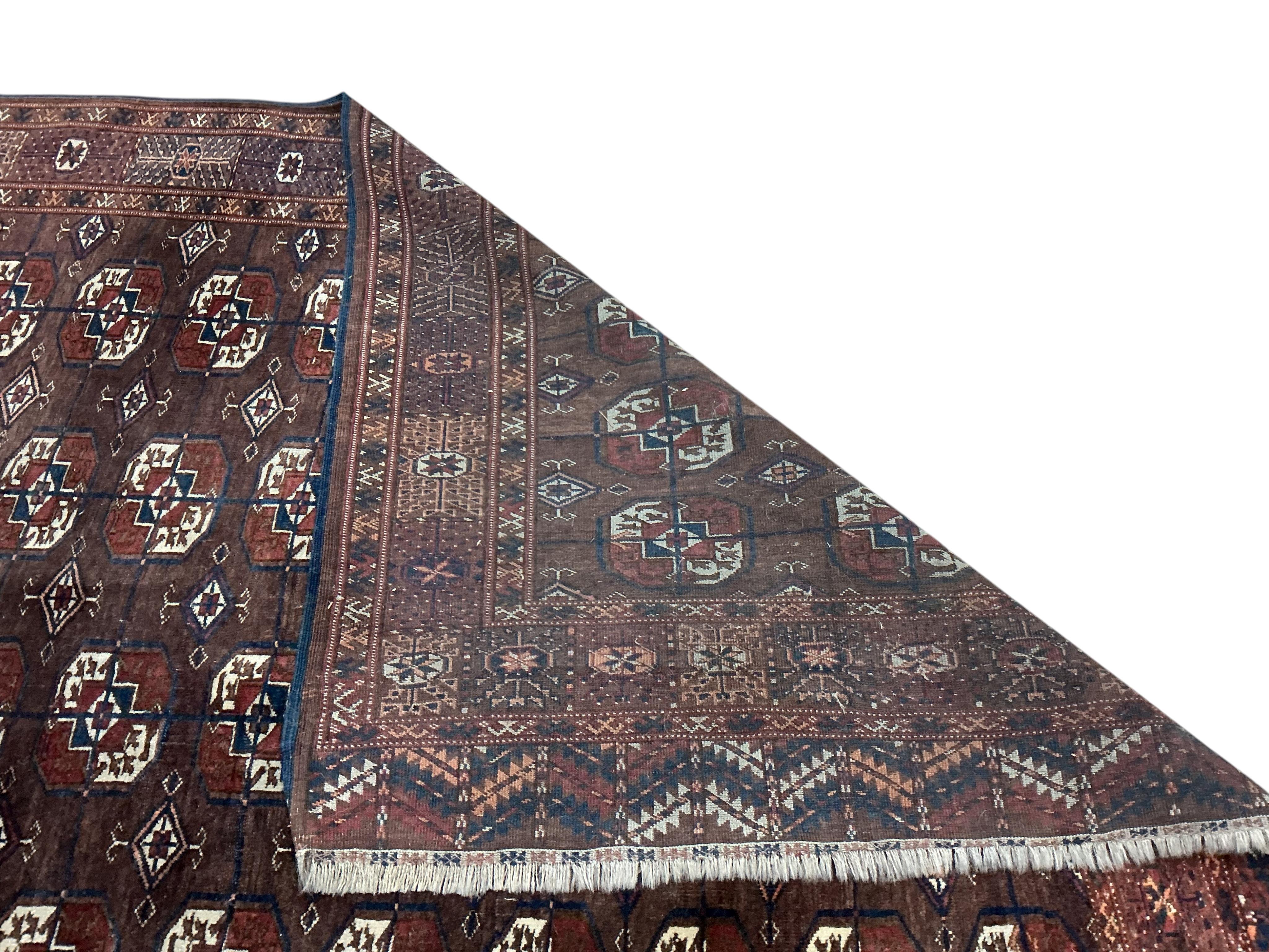 A Tekke Turkoman burgundy ground rug, 260 x 166cm